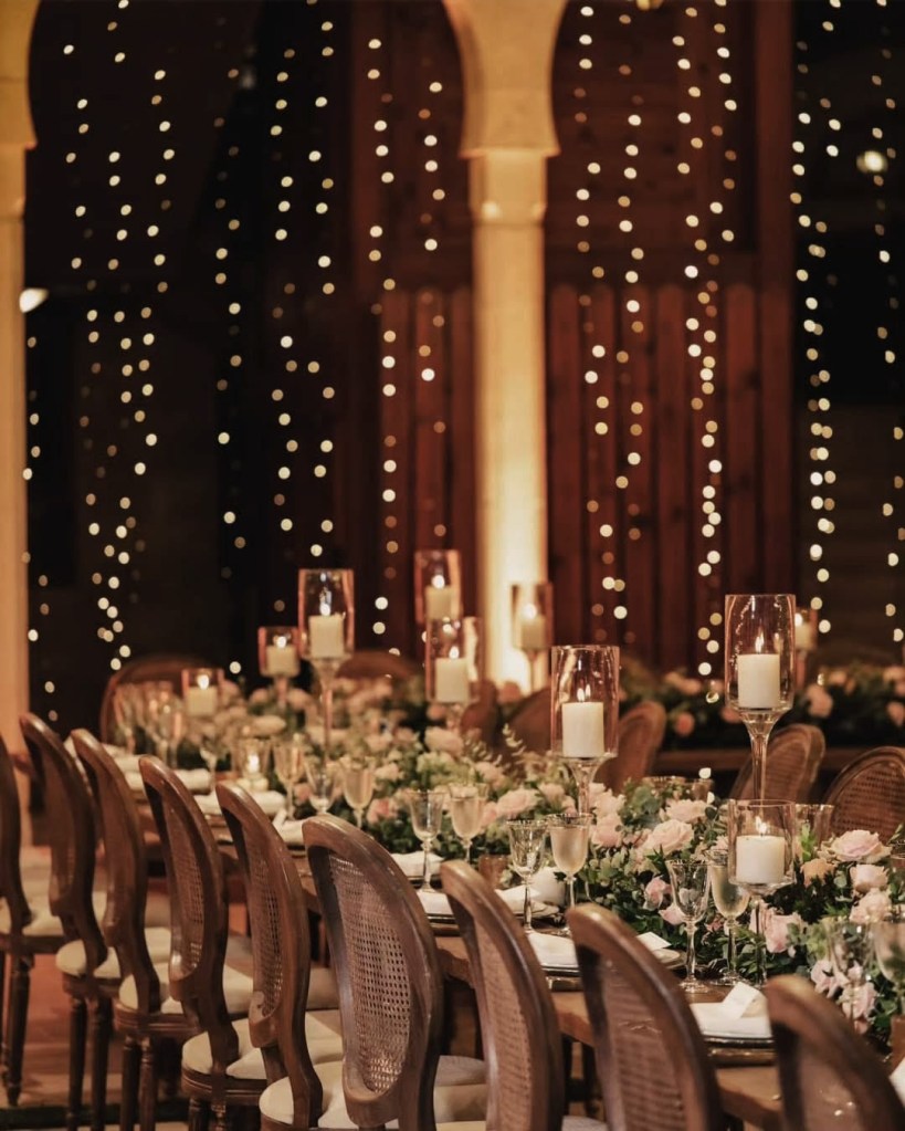 Luxury wedding table decor with candles and floral arrangement